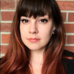 headshot photo of a woman with bangs and long hair