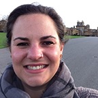 photo of a woman with tied back hair smiling